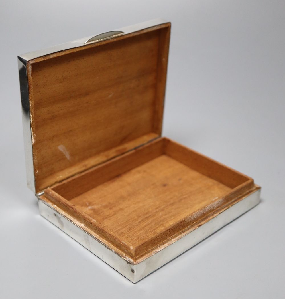 A cased set of six silver bean end coffee spoons, a silver cigarette box and two white metal dishes.